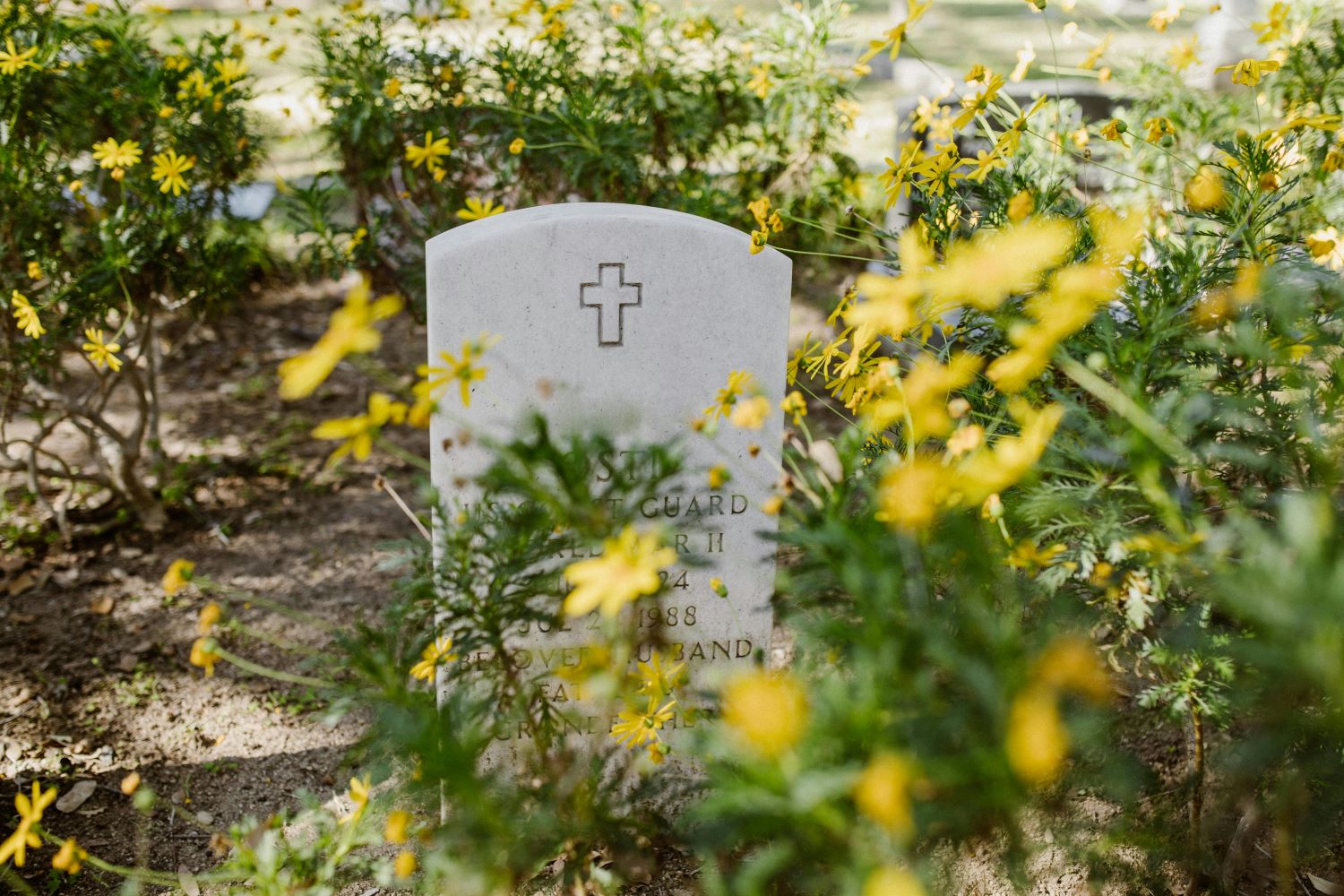 image of a white headstone with a cross on the top